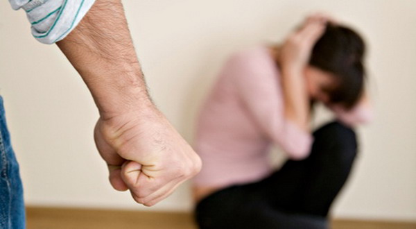 Man with clenched fist and woman cowering